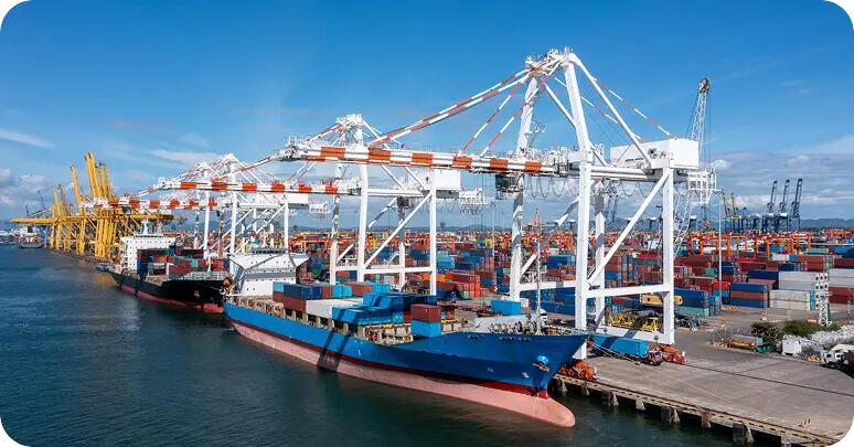 Container ship docked at a busy shipping terminal